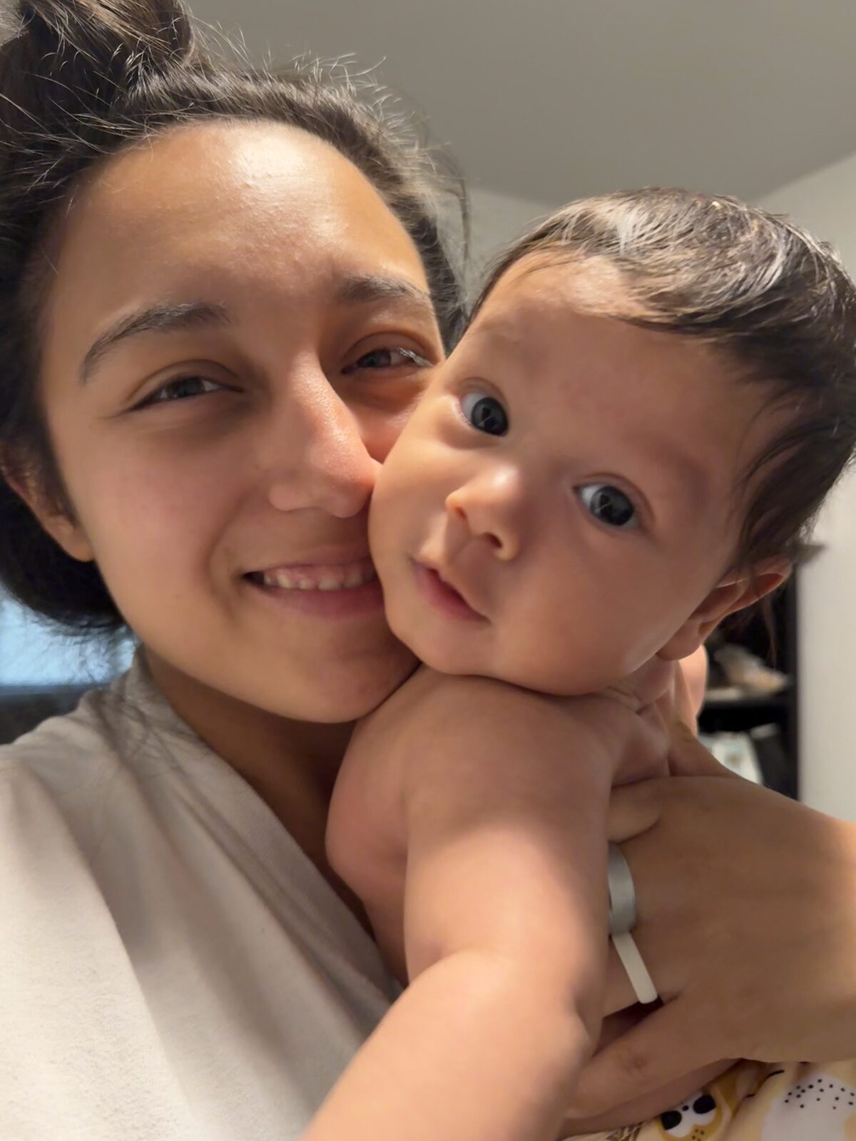 Jackie holding her baby son, cheek to cheek